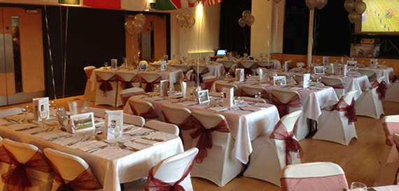 Hall set with cream and burgundy chair sashes and balloon displays