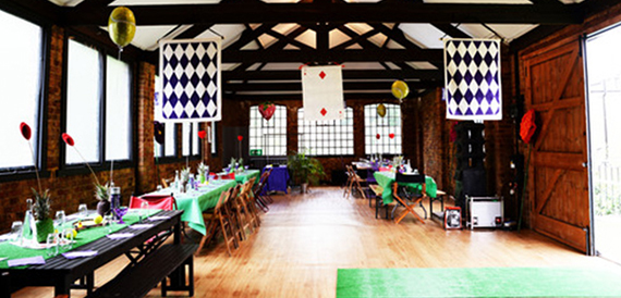 Studio decorated for a casino night with playing card banners and baize tables
