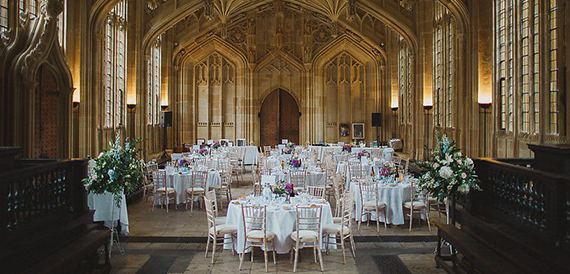 Bodleian Libraries hall set with round wedding tables beneath vaulted stone arches