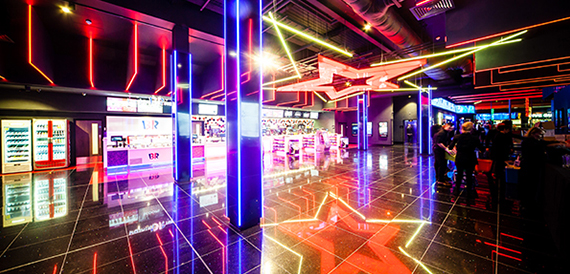 Arcade area with neon lighting and games machines