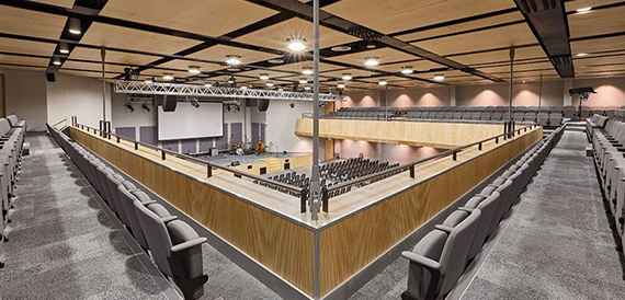 Wide view of the auditorium's balcony seating and wood-panelled rail