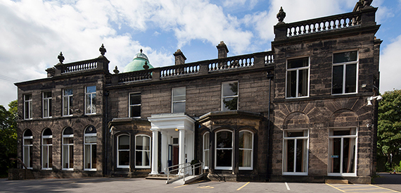 Castle Grove's stone exterior with a columned portico entrance