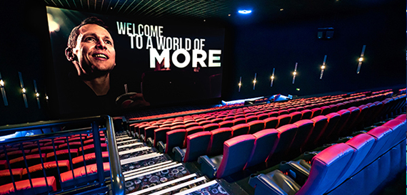 Auditorium seating facing a screen showing a welcome message