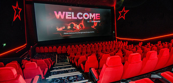 Auditorium red seats facing a screen reading Welcome to Cineworld