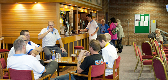 Bar area with beer pumps and members chatting