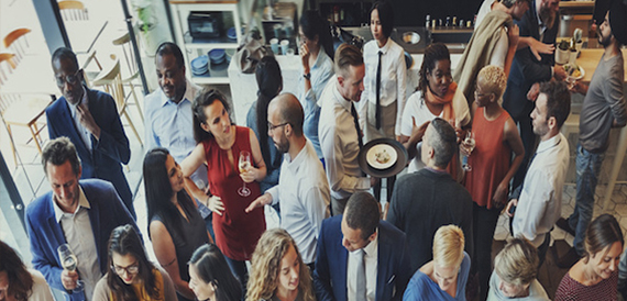 Guests mingling with drinks at a networking reception