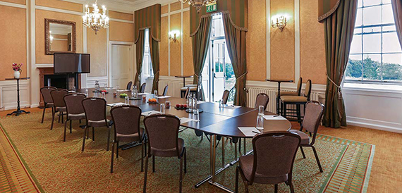 Boardroom with an oval table and French doors to the garden