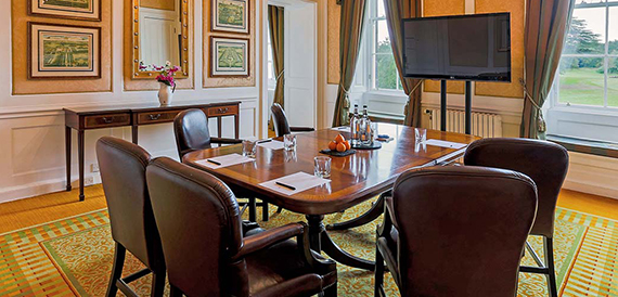 Small boardroom with leather chairs around a dark wood table