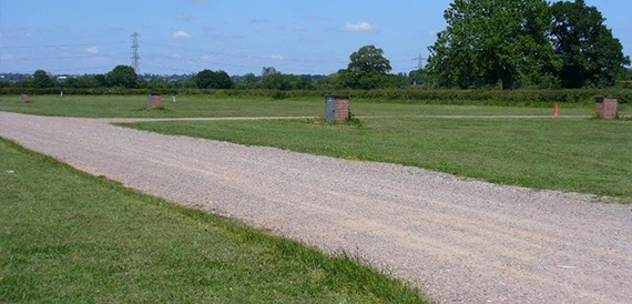 Gravel track running through open countryside at the showground.