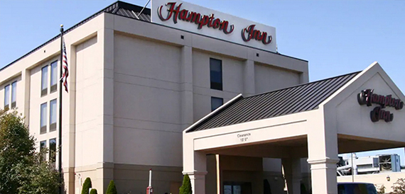 Exterior of the hotel building with signage above the entrance canopy.