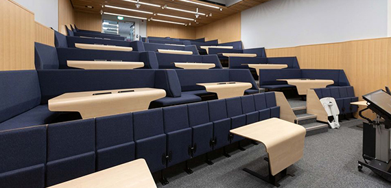 Tiered lecture theatre seating with fold-out writing desks