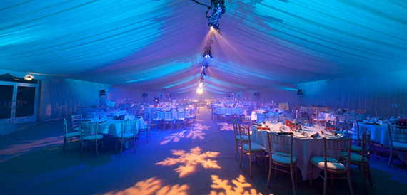 Marquee dinner set-up with blue lighting and snowflake floor projections