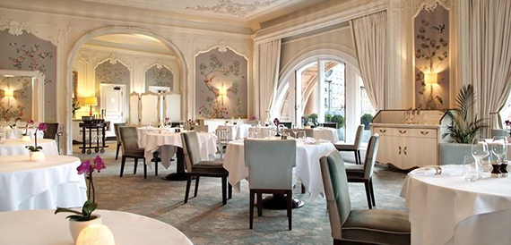 Elegant dining room with a round table and floral wallpaper