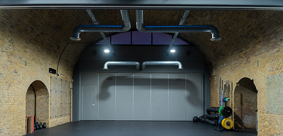 Brick vaulted training hall with a partition wall and weight rack