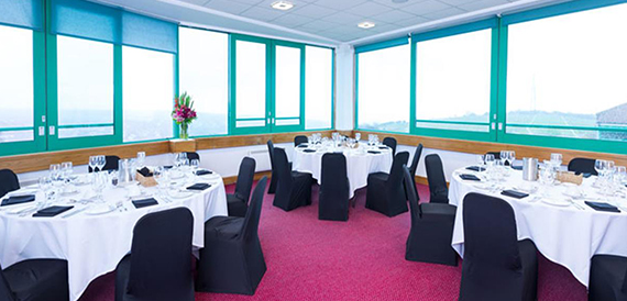 Private dining room with round tables and turquoise-framed windows