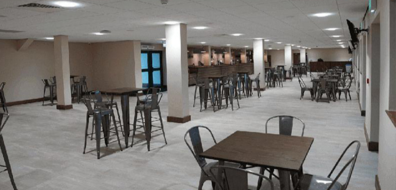 Casual dining area with high tables, bar stools and exposed columns