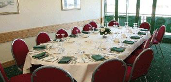 Private dining room with a long table set for a formal meal.