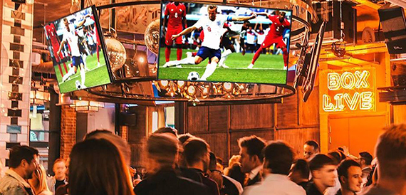 Crowd gathered to watch football on a large screen