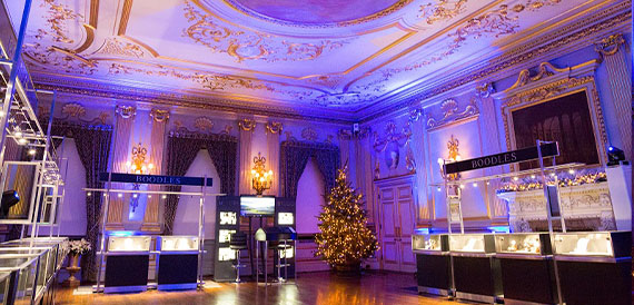 Ornate ballroom decorated with blue lighting for a jewellery showcase event