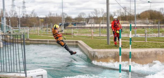 Kayaker mid-jump on the white water rapids course