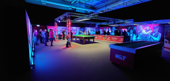 Snooker exhibition event with colourful stage lighting and WST branding