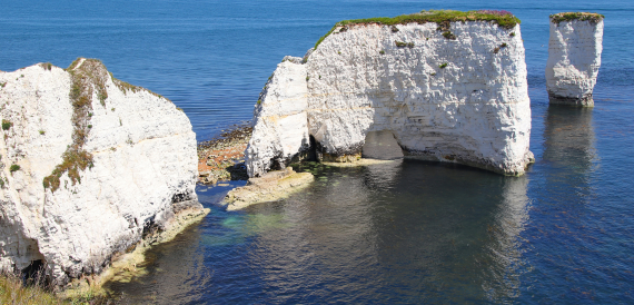Chalk cliffs and a sea arch along the Dorset coastline