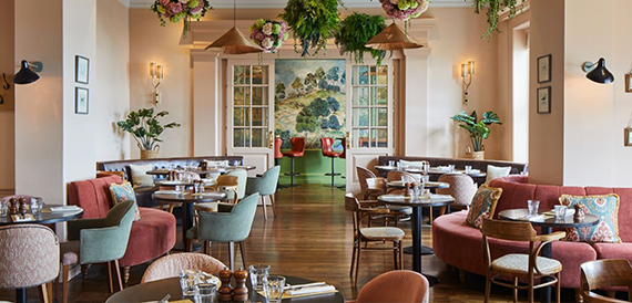 Brasserie dining room with colourful upholstered chairs and mirrored walls