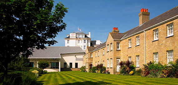 Bournemouth Highcliff Marriott's stone hotel exterior beside a manicured lawn