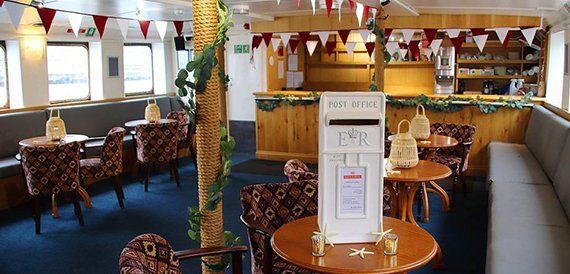 Boat function room decorated with bunting and a mock post box