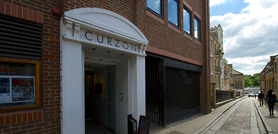 Curzon's white arched entrance set into a brick building