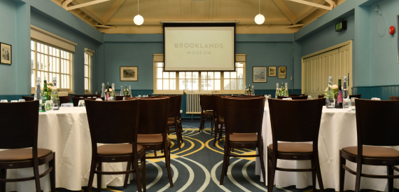 Brooklands Museum hall set boardroom-style beneath a vaulted ceiling