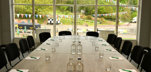 Boardroom table overlooking the race track and bunting outside