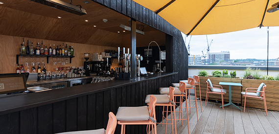 Rooftop bar counter with a view of the city skyline