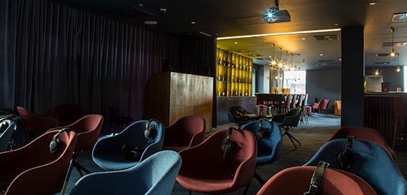 Function room with red walls, round tables and balloon decorations