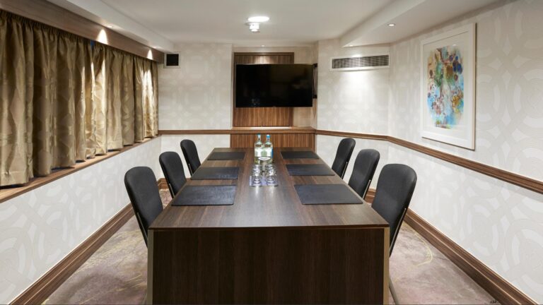 Boardroom set U-shaped with black chairs and gold curtains