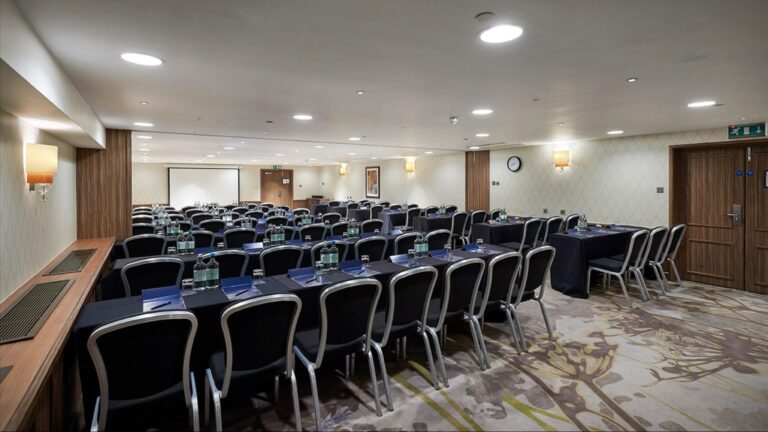 Kensington Suite set classroom-style with blue-clothed tables and black chairs