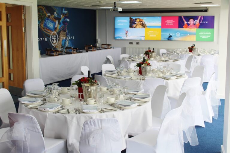 Hospitality suite with round tables set formally overlooking the pitch